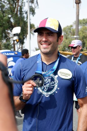 Gerald shows off his medal for finishing the marathon.
