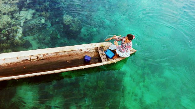 A local woman crosses the Sanga-Sanga channel.